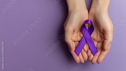 World Alzheimer's day. September 21. International Epilepsy Day. Adult hands holding purple ribbon on purple background. World Lupus Day and world cancer , 