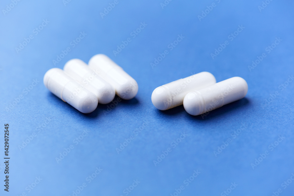 Arginine capsules on bright background. Soft focus. Close up. Copy space. Arginine capsules on bright background. Soft focus. Close up. Copy space.