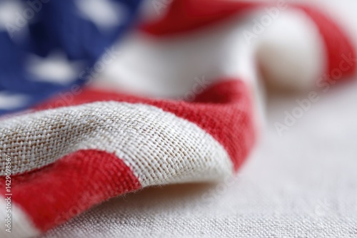 singular close-up of fabric of usa flag capturing intricate weave of red white and blue colors with minimalistic composition