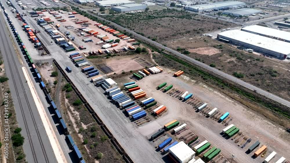 Aerial view of an industrial railway terminal with freight train tracks and colorful shipping containers in San Luis Potosí, Mexico