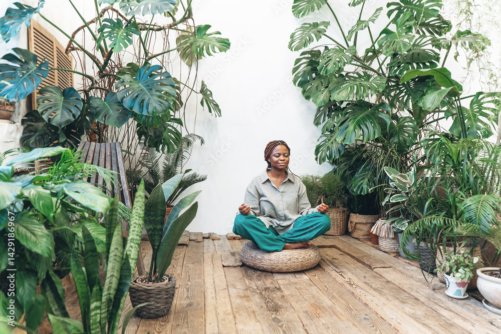 A woman meditates in a calm and serene environment of a green garden