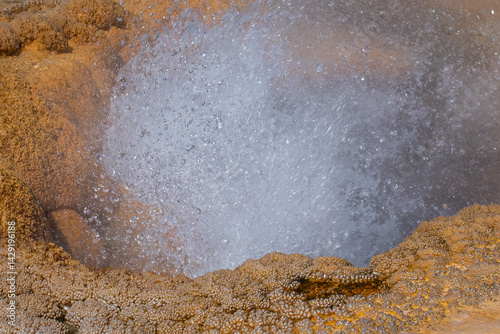 Sparkling pearls of geyserite around errupting geyser. photo