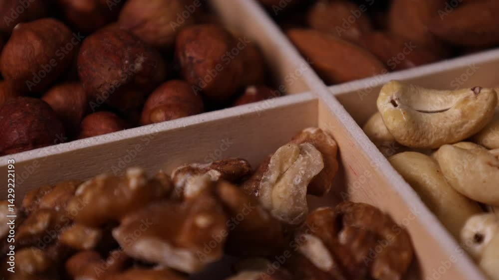 Wooden tray with a set of healthy fresh nuts close-up, healthy eating concept Wooden tray with a set of healthy fresh nuts close-up, healthy eating concept