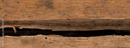 Obraz na płótnie Cracked wooden surface reveals natural textures and patterns in warm light w salonie