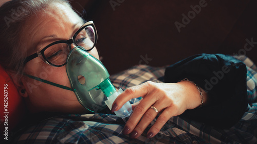 Asthma therapy – woman holding inhaler during breathing difficulty