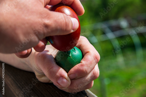 Easter theme and knocking colored eggs, kids knock eggs for Easter holiday.