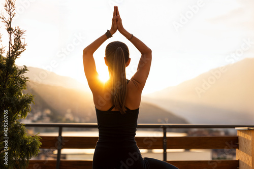 The image shows a person practicing yoga on a balcony with a beautiful sunset in the background
