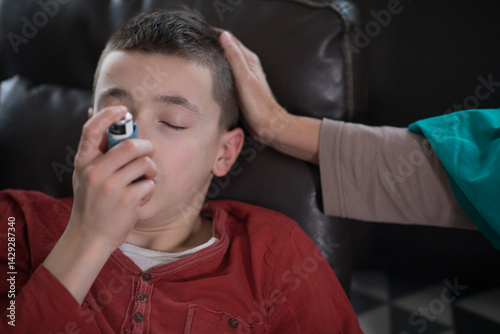Pediatric asthma – little boy with inhaler at home
