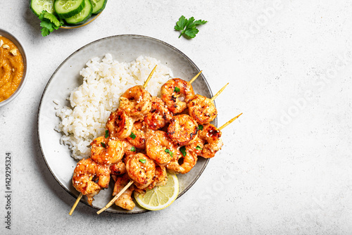Grilled shimp prawn satay skewers with steamed rice photo