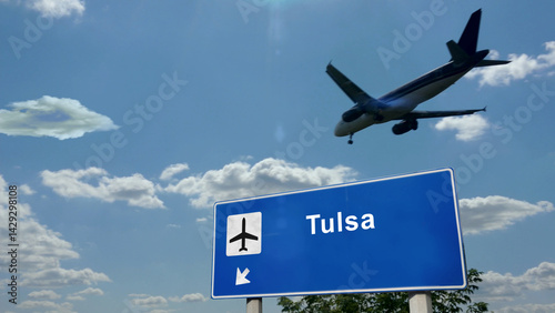 Obraz na płótnie Plane landing in Tulsa Oklahoma, USA, airport with signboard w salonie