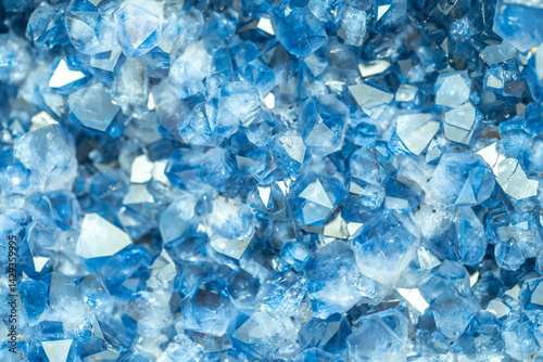 Blue Crystal Mineral Stone. Gems. Mineral crystals in the natural environment. Texture of precious and semiprecious stones. Seamless background with copy space colored shiny surface of precious stones