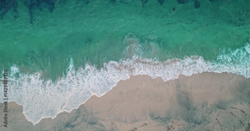 Capturing stunning aerial views of turquoise waters gently lapping the pristine sands of Bias Tugel Beach, a hidden Bali gem, creates a breathtaking tropical paradise