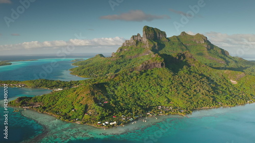 Obraz na płótnie Stunning aerial view of Bora Bora island, French Polynesia, showcasing the iconic mount Otemanu, turquoise lagoon, lush green vegetation, and idyllic overwater bungalows during a sunny day w salonie
