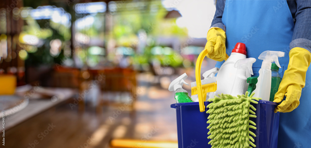Woman with different cleaning supplies and products at outdoor cafe, closeup. Banner design with space for text