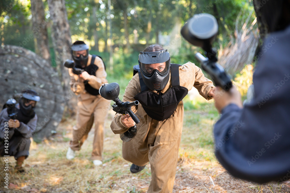 Fototapeta premium Team of paintball players attacks the enemy at an army training ground