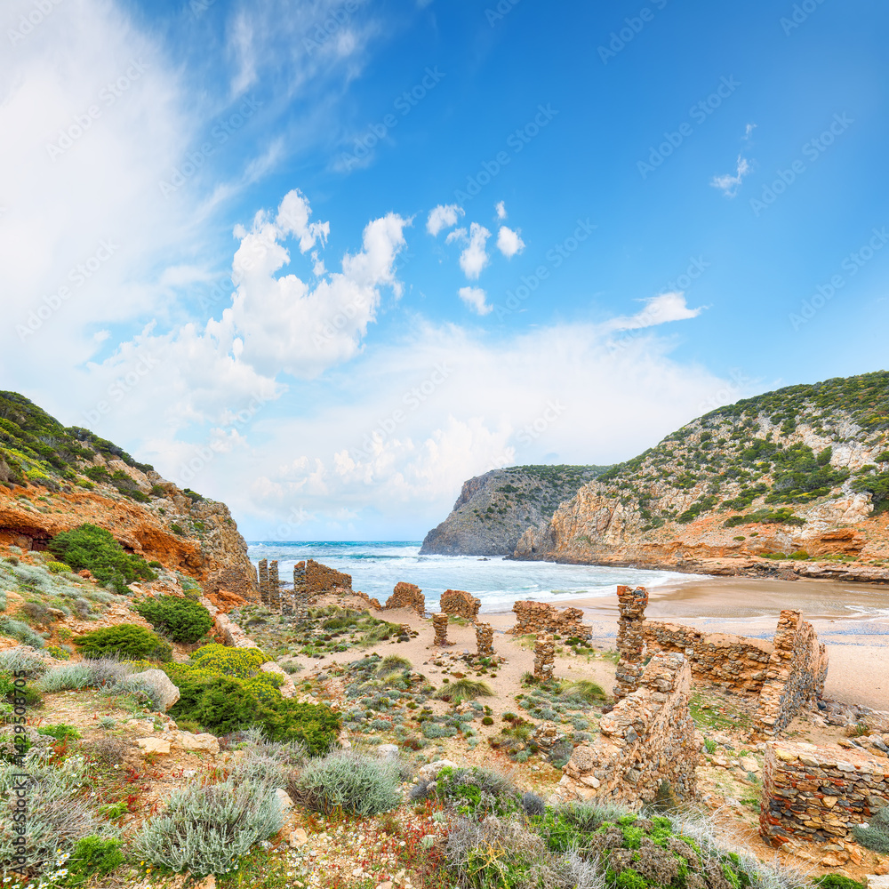 Attractive view of valley Cala Domestica with marvelous sand beach and ruines of old village