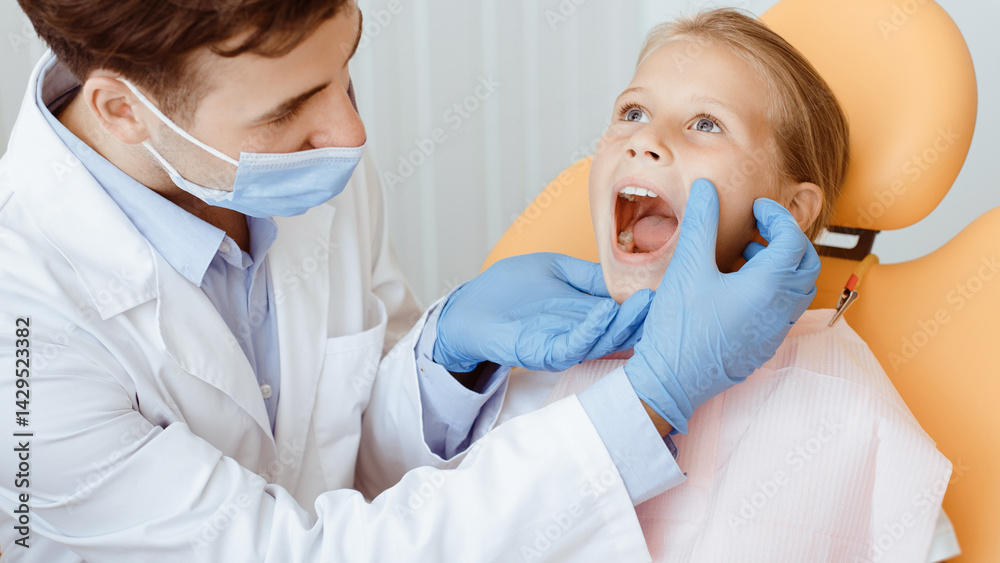 Professional procedure and stomatology pain. Hands of unrecognizable pediatric dentist making examination procedure for smiling cute little girl sitting on chair in modern clinic, cropped, panorama Professional procedure and stomatology pain. Hands of unrecognizable pediatric dentist making examination procedure for smiling cute little girl sitting on chair in modern clinic, cropped, panorama