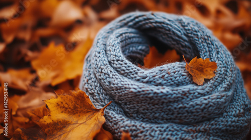 Obraz na płótnie Close-up of a knitted scarf against a backdrop of swirling autumn leaves. w salonie