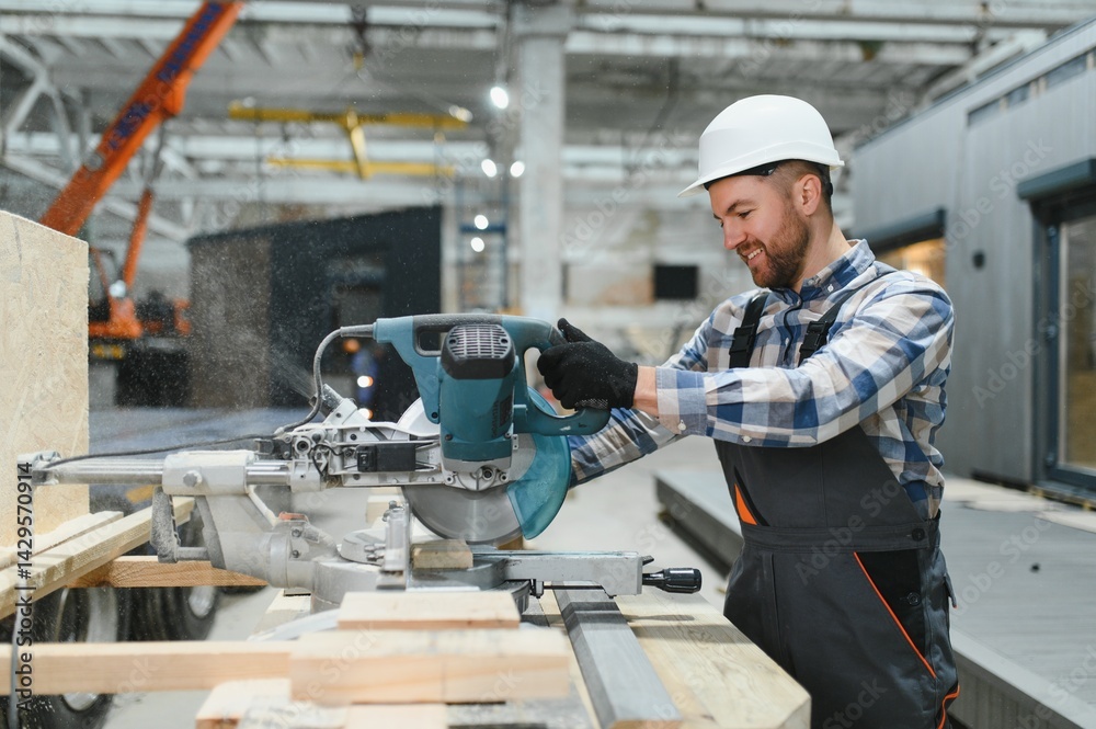 A worker uses a sawmill to process wood. Construction of modern modular houses. A worker uses a sawmill to process wood. Construction of modern modular houses.