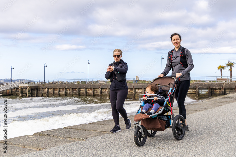 Women Jogging With Stroller on West Vancouver Centennial Seawalk, BC, Canada
