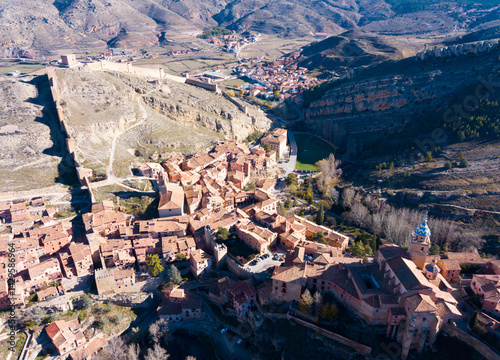 Aerial view of tiled housetops and defensive wall of medieval town Albarracin, Spain