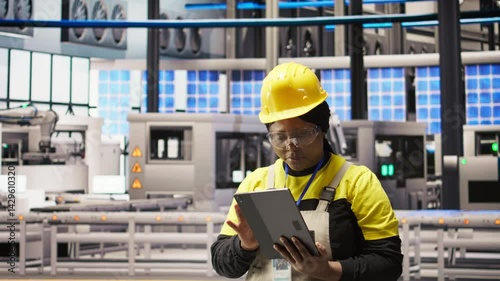 Wallpaper Mural Woman working in solar panels plant uses tablet to oversee machinery systems. African american photovoltaics plant employee uses software on device to maintain operations, camera A Torontodigital.ca