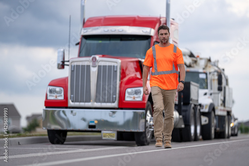 Portrait of happy truck driver looking at camera. Truck Drivers Checking the Truck's Safety Maintenance Checklist. Inspection Safety of Semi Truck Wheels Tires. Mechanic Auto Service Shop.