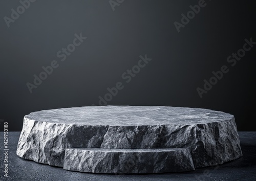 Gray stone podium.  A circular, textured stone platform on a dark surface.  Natural, rough-hewn edges