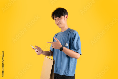 a man with brown shopping bag while holding a phone and pointing at it