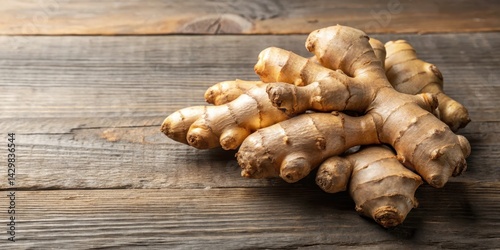 Aromatic and pungent fresh ginger root with visible scales and a brownish-gray skin , spice