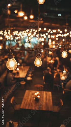 A restaurant with a lot of people and lights hanging from the ceiling. The lights are dim and the mood is cozy