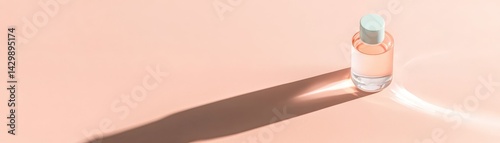 Obraz na płótnie A minimalist perfume bottle casts a soft shadow on a pale pink surface, creating an elegant and serene atmosphere. w salonie