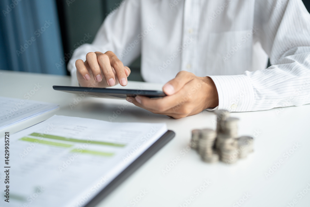 Business man holding digital tablet using Stock market application and reviews finances and manages budget with money cash Business man holding digital tablet using Stock market application and reviews finances and manages budget with money cash
