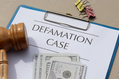 Civil Litigation Filed: Defamation Case Form on Wooden Surface photo