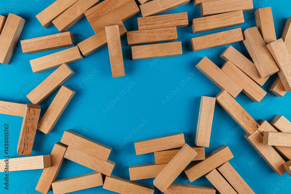 Wooden blocks scattered on a blue surface for creative play