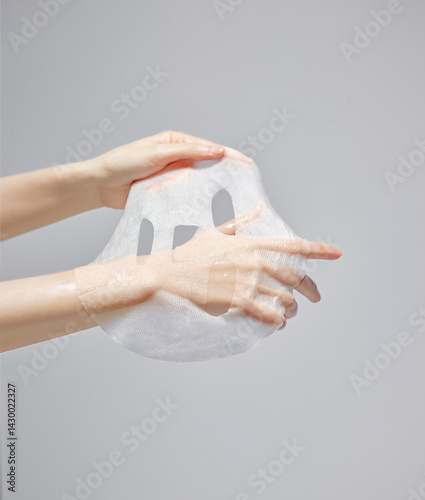 A woman's hand on a mask sheet