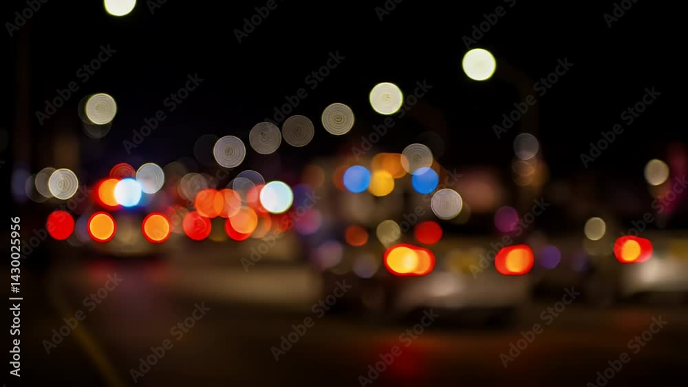 Emergency Vehicle Lights Blurring at Night on City Street