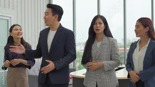 Businessmen congratulate each other on the success of sales exceeding the target, smooth business negotiations, shaking hands and applauding.
