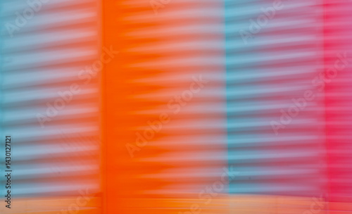 abstract blur of red orange and blue or turquoise corrugated metal special blurry effect created by long time exposure and intentional camera movement horizontal blurred backdrop background wallpaper 