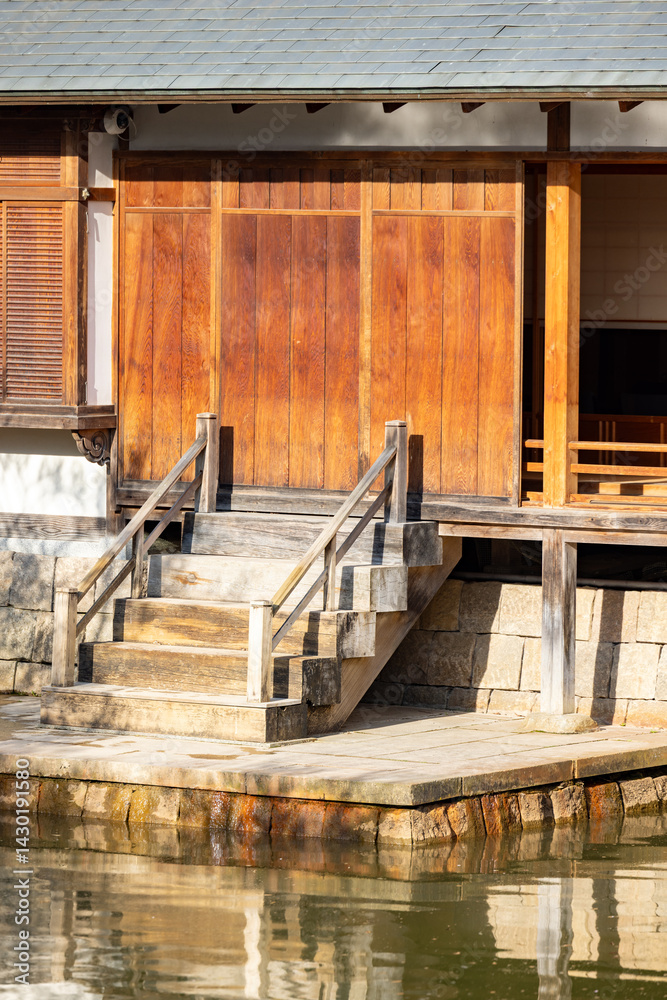 Obraz premium Rustic wooden steps gracefully leading to a serene water view, beautifully showcasing traditional architectural design
