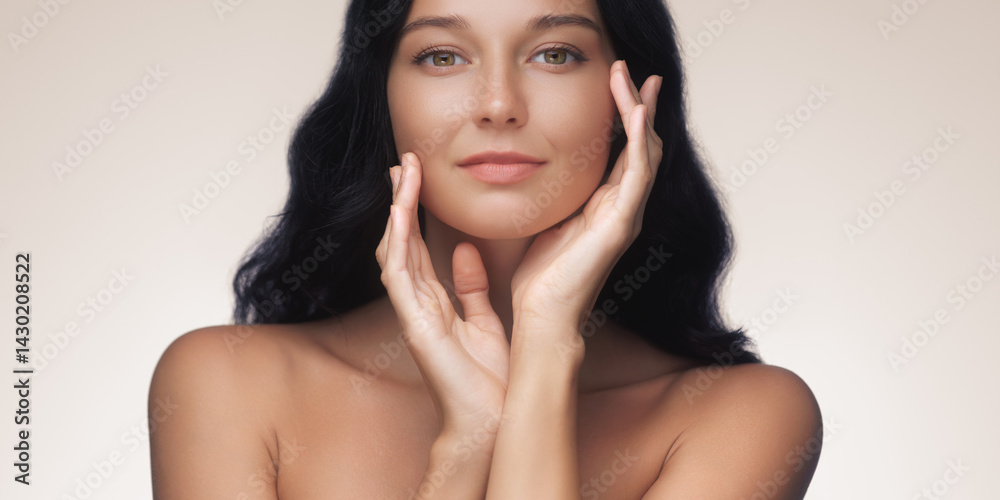 An elegant Asian woman with long black hair poses gracefully with her hands near her face, showcasing flawless skin and natural beauty. Ideal for beauty, skincare, and cosmetics advertisements