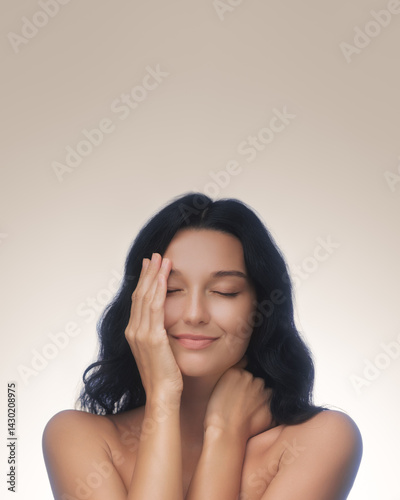 An elegant woman with dark hair and radiant skin smiles peacefully with her eyes closed, gently touching her face, highlighting her serene beauty. Ideal for wellness, skincare, and beauty marketing