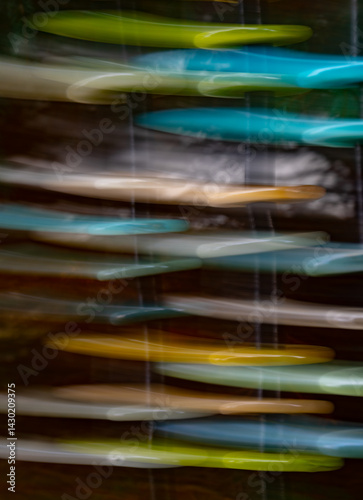 abstract motion blur  of colored tiles stacked upright special effect created with long shutter speed and ICM or intentional camera movement creating a falling or vertical appearance colorful backdrop