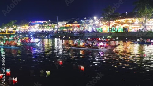 Nighttime boat journey highlighting hoi an's luminous charm, floating lanterns glimmering across thu bon river's surface during mesmerizing timelapse capture