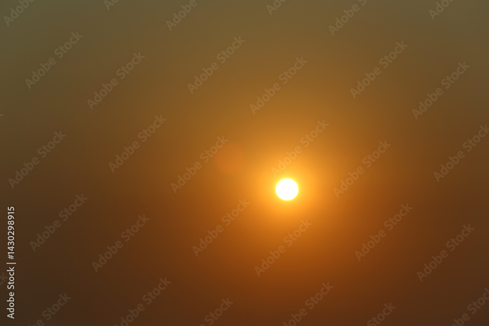 Twilight sky with the sun setting and a beautiful golden yellow light.