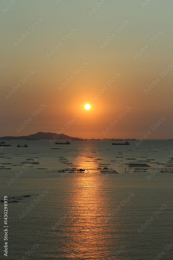 Sea is filled with cargo ships and fishing boats at dusk. Sea is filled with cargo ships and fishing boats at dusk.
