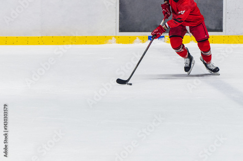 Ice hockey, winter team sport. Hockey rink with skating player in red uniform