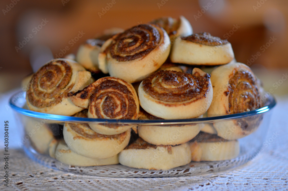 pile of poppy seed and walnut strudels in the ceramic bowl at the table