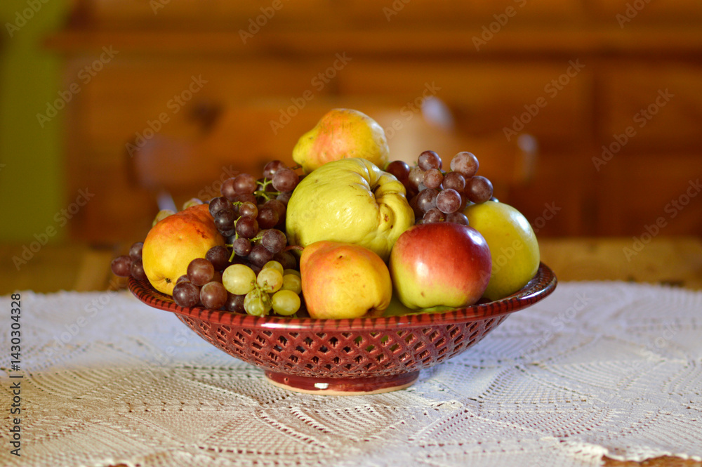 ceramic bowl with various ripe fruits at the table