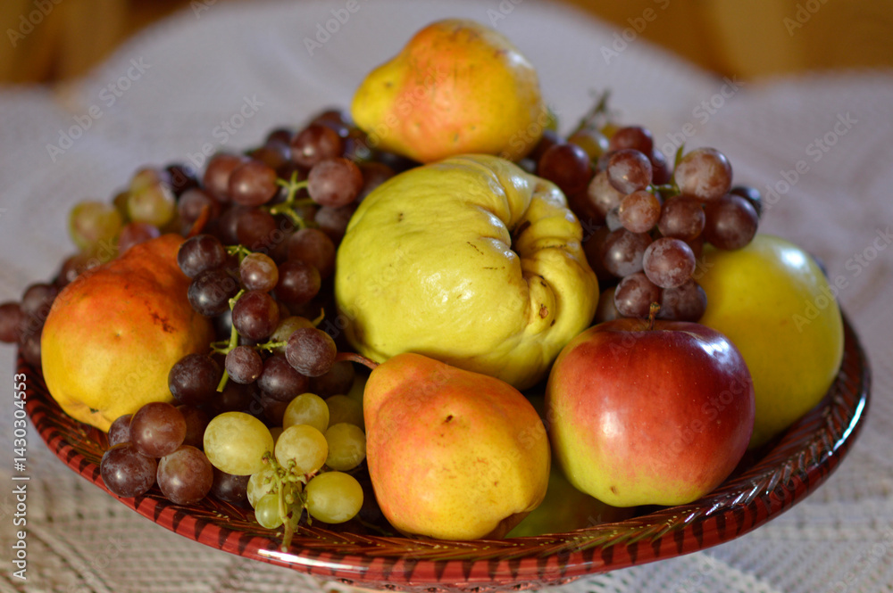 ceramic bowl with various ripe fruits at the table